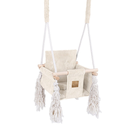 Children's swing with white ropes and fringes